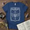 Alchemy Of The Night t-shirt design featuring a white moth, alchemical symbols, and the text "ALCHEMY OF THE NIGHT" and