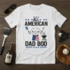 All American Dad Bod t-shirt design featuring patriotic text and graphics of a muscular man grilling