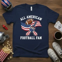 All American Football Fan text with USA flag and football on a navy t-shirt, featuring a hand in a foam