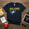 Navy t-shirt with yellow text "ALL CAPS EVERYTHING LOUD & CLEAR" and a graphic of a megaphone with an exclamation