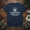 Navy t-shirt with white text quote "ALL GOOD THINGS ARE Wild & Free" by Henry David Thoreau, featuring a circular