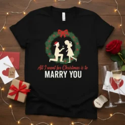 All I want for Christmas is to MARRY YOU text with a Christmas wreath proposal graphic on a black t-shirt