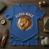 Alpha Male text above a lion's head graphic, surrounded by floral wreath, on a blue t-shirt