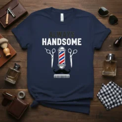 Navy blue t-shirt with "ALWAYS HANDSOME" text and barber pole, scissors, mustache, and comb graphic