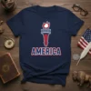 Navy blue t-shirt with "AMERICA" text and a red, white, and blue torch graphic, symbolizing patriotism