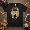 American Football text with a dripping effect, player silhouette, and football graphic on a black t-shirt