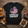 Black t-shirt with "AMERICAN HARVEST" text below a pumpkin filled with the American flag design