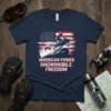 American Power Snowmobile Freedom text with American flag and snowmobiler graphic on a navy t-shirt