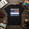 American flag merged with transgender flag, text "American By Birth Transgender By The Grace Of God" on a black t-shirt