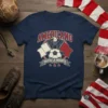 Americano Hasta La Muerte text with eagle, flags, and soccer ball graphic on navy t-shirt