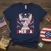 Navy blue t-shirt design featuring an AMERICAT Sphynx cat wearing USA flag sunglasses with red, white, and blue starbursts