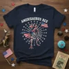 Amerisaurus Rex design on a navy t-shirt, showing a T-Rex skeleton wearing sunglasses and a cape, holding an American flag