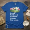 Blue t-shirt with the names Anne & Matthew & Giathew & Diana & Mrs. Lynde and a whimsical illustration of