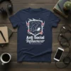 Anti Social Influencer t-shirt design featuring a hooded figure on a laptop within a shield emblem, surrounded by prohibition signs