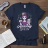 Anxiety Queen t-shirt with illustration of a crowned woman holding coffee and books, featuring purple and pink text