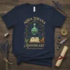 Aqua Tofana Apothecary T-Shirt design featuring vintage illustration of potion bottle, open book, mortar and pestle, and floral accents