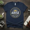 Arise New Day Awaits t-shirt with a circular sunrise graphic in gold and white on a navy blue tee