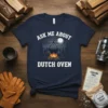 Ask Me About Dutch Oven text with campfire cooking graphic on navy t-shirt