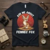 Ask Me About Fennec Fox t-shirt design featuring a cute fennec fox sitting in front of a sunset graphic