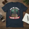 Ask Me About Maine Coon t-shirt with a grey cat sitting on books titled Cat Breeds, Feline Anatomy, and History