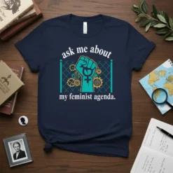 Navy t-shirt with "ask me about my feminist agenda" text and a teal raised fist graphic with gears