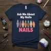 T-shirt design with text "Ask Me About My Nails" above a row of diverse hands with elaborate nail art. Below