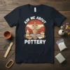 Ask Me About Pottery t-shirt design featuring hands shaping clay on a pottery wheel, with surrounding pottery pieces