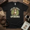 Black t-shirt with "Ask Me About Spinone" text and a cartoon Spinone dog illustration inside a circle