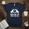 Christian t-shirt with white text "Ask Me To Pray For You" and heart hands graphic on navy blue