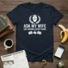 Navy t-shirt with "Ask My Wife She Knows Everything" in white text, featuring a laurel wreath and crown graphic above