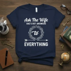 Ask The Wife SHE'S GOT ANSWERS to EVERYTHING quote on a navy blue t-shirt, featuring decorative wreath and arrow graphic