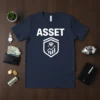 Navy blue t-shirt with the word "ASSET" in white, above a shield graphic containing a diamond and a stock market