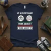 Navy t-shirt with "At a Close Range We Are All the Same Think About It" text and eyeglass graphic showing