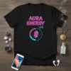 Black t-shirt with "AURA ENERGY 67%" in pink and teal, featuring a crystal in a circular progress bar graphic