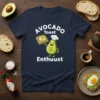 Avocado Toast Enthusiast t-shirt design featuring a happy avocado character holding avocado toast, with "Avocado Toast Enthusiast" text