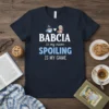 Babcia is my name SPOILING IS MY GAME quote on a navy t-shirt with a cute grandma graphic and coffee
