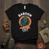 Baboon Girl T-Shirt with a colorful illustration of a baboon sitting in front of a circular graphic