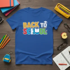 Back To School text design with an open book, graduation cap, and pencil graphic, displayed on a blue t-shirt
