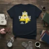 Navy t-shirt with "BAD EXAMPLE" text inside a yellow warning triangle, featuring a broken lightbulb and pile of dirt graphic