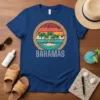 Bahamas text with flamingos, palm trees, and ocean on a vintage circular design, t-shirt graphic