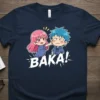 Baka! Japanese insult quote in bold white text with chibi anime girl poking boy's cheek on a navy t-shirt