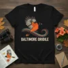 Baltimore Oriole bird graphic t-shirt with colorful wavy lines and text "BALTIMORE ORIOLE"