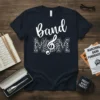 Band Mom T-Shirt with white script text and leopard print filled MOM letters with musical notes and treble clef