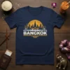 Navy blue t-shirt featuring a yellow and white Bangkok skyline silhouette against a sun graphic