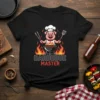 Barbeque Master T-Shirt with a cartoon chef pig grilling over flames, holding tongs and a spatula