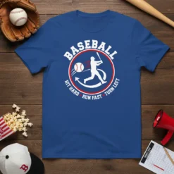 Baseball player swinging bat graphic with text "Baseball Hit Hard Run Fast Turn Left" on a blue t-shirt