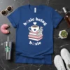 Basic Being Basic t-shirt design with coffee cup, stack of books, and cozy socks. Features white text and pastel graphics