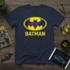 Navy blue t-shirt featuring the yellow Batman logo with a colorful galaxy design inside, and the word BATMAN below