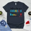 T-shirt with text "battery life of a NURSE" and battery level graphics representing Tuesday, Wednesday, Thursday, and Christmas