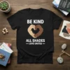 Black t-shirt with "BE KIND ALL SHADES - LOVE UNITES" text and hands forming a heart in different skin tones